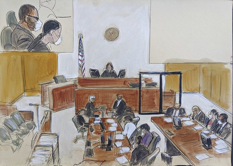 In this courtroom sketch drawn from a video feed, Judge Ann Donnelly sits at the judge's bench and reads the instructions to the jury (not visible on the video feed) during R. Kelly's sex trafficking trial in federal court in New York on Friday, Sept. 24, 2021. R. Kelly is seen in the upper left hand corner inset and is seated lower right. (AP/Elizabeth Williams)