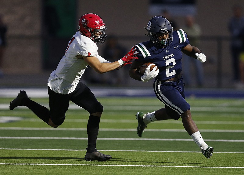 Little Rock Christian running back Jayvean Dyer-Jones (2) runs past Maumelle safety Maxwell Pace (1) during the first quarter of the Warriors' 16-10 win on Friday, Sept. 24, 2021, in Little Rock. (Arkansas Democrat-Gazette/Thomas Metthe)