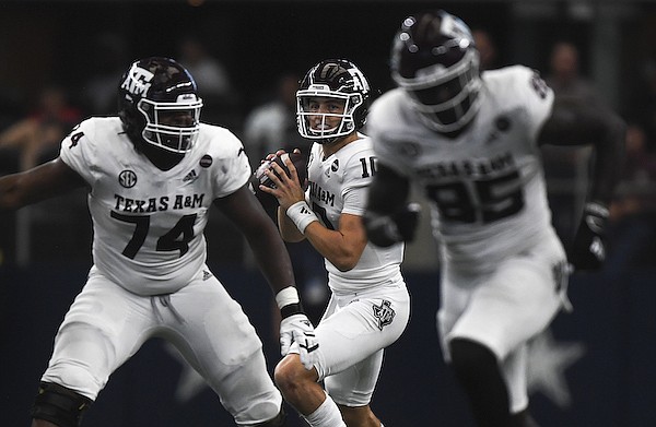 Texas A&M quarterback Zach Calzada (10) looks to pass during a game against Arkansas on Saturday, Sept. 25, 2021, in Arlington, Texas.