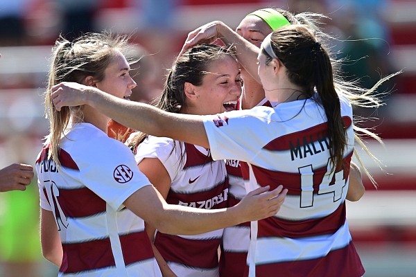 Taylor Malham celebrates with Arkansas teammates during a game against Ole Miss on Sept. 26, 2021 at Razorback Field in Fayetteville.