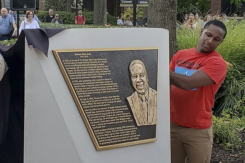 Brandt Jean, a current Harding University student and the brother of Botham Jean, helps unveil the memorial plaque to his brother Wednesday at Harding University in Searcy. Botham Jean was shot to death in 2018 by a Dallas police officer who said she mistakenly thought she was in her apartment and that he was an intruder.
(Arkansas Democrat-Gazette/Ashton Eley)