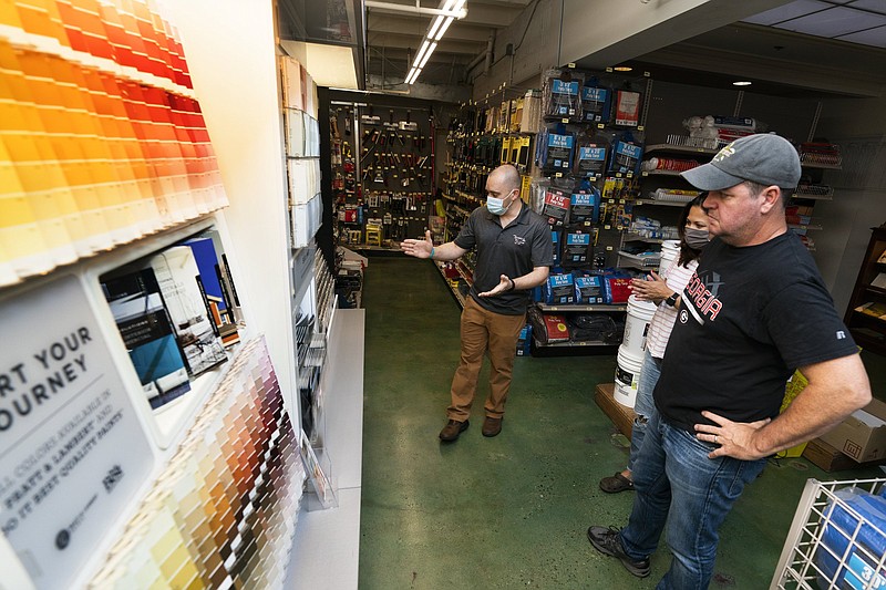 Billy Wommack (left), purchasing director at W.S. Jenks & Sons hardware, works with customer Tim Wood on an outdoor paint color for his house Friday in Washington, D.C.
(AP/Manuel Balce Ceneta)