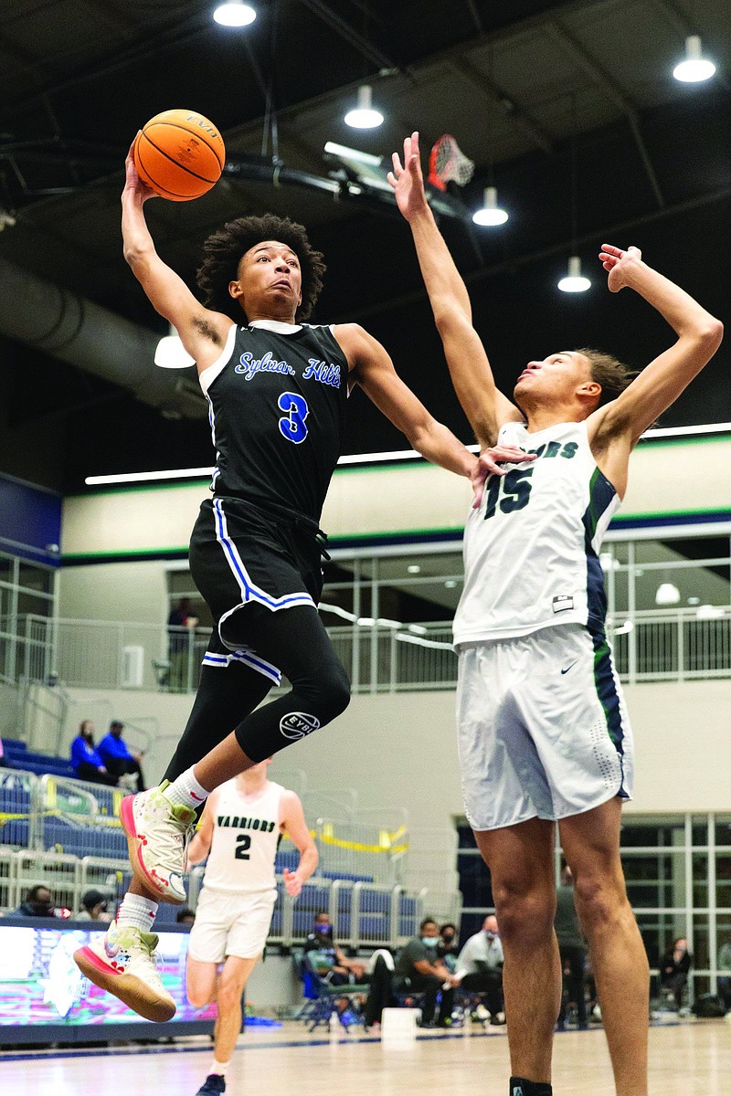 Nick Smith (left), seen here playing for Sylvan Hills in February, announced his commitment to the University of Arkansas on Wednesday night. Smith, a guard who will play his senior season of high school basketball at North Little Rock, is ranked as a five-star recruit by ESPN.
(Arkansas Democrat-Gazette/Justin Cunningham)