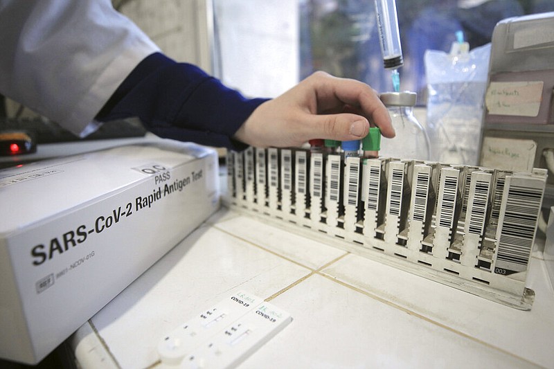 A nurse arranges antigen covid-19 tests in a private laboratory in this Dec. 6, 2020, file photo. Antigen tests, commonly called rapid tests, detect protein fragments specific to the coronavirus. It is different that a PCR test, which detects genetic material specific to the virus. (AP/Fateh Guidoum)