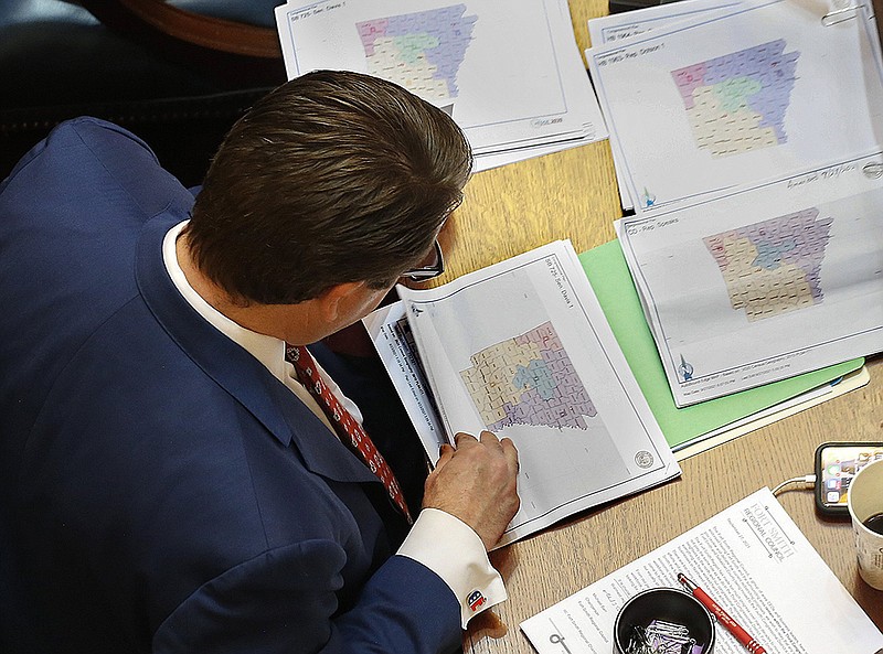 Sen. Jason Rapert looks over proposed congressional redistricting maps during the Senate session. Rapert said it was his understanding that no compromise had been reached between the Senate and the House over how the districts would be redrawn. More photos at arkansasonline.com/930session/.
(Arkansas Democrat-Gazette/Thomas Metthe)