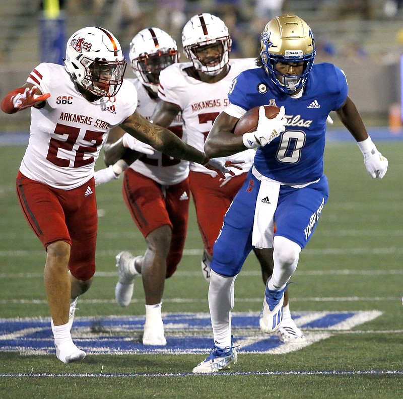 Caleb Bonner (22) and other Arkansas State defenders attempt unsuccessfully to catch Tulsa’s Ezra Naylor during ASU’s loss last Saturday. The Red Wolves rank last nationally in total defense, allowing 569.8 yards per game.
(AP/Tulsa World/Rip Stell)