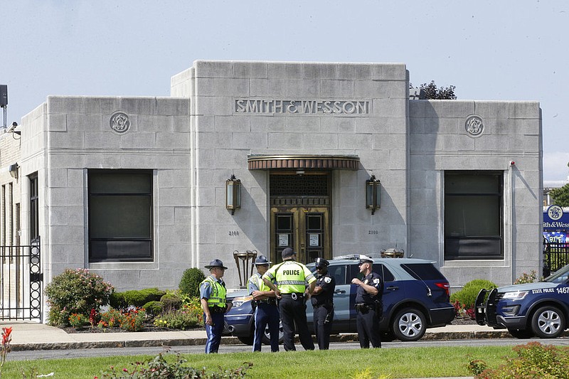 Law enforcement officers stand near an entrance to the headquarters of gun manufacturer Smith & Wesson in Springfield, Mass., in this Aug. 26, 2018, file photo. (AP/Steven Senne)