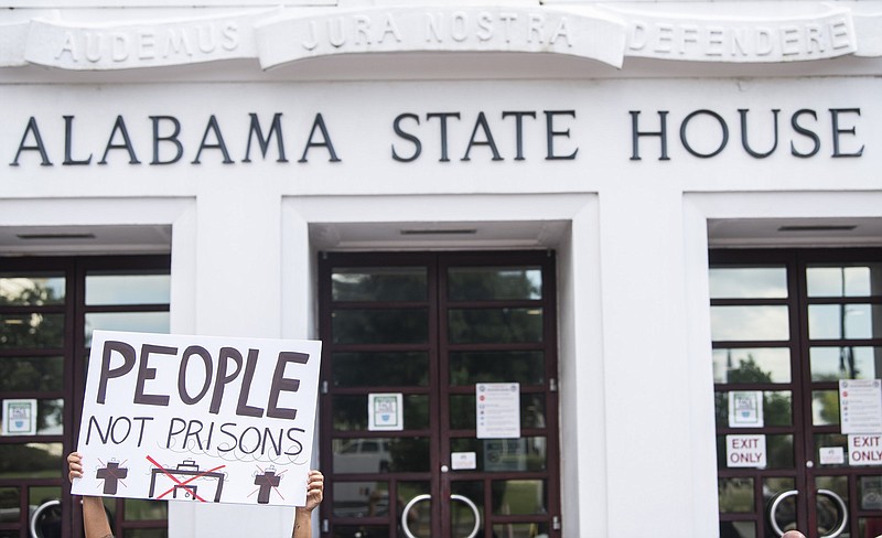 People protest the prison plan Wednesday at the Alabama State House in Montgomery.
(AP/The Montgomery Advertiser/Jake Crandall)