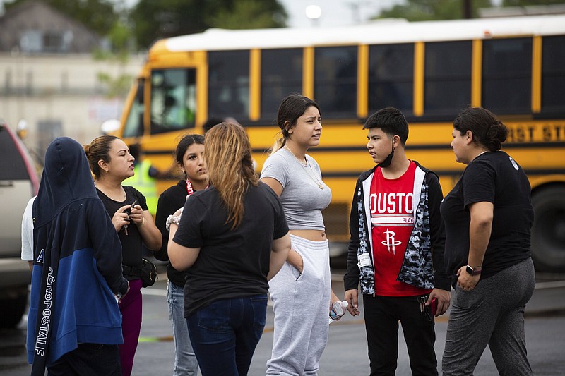 Families wait to pick up their children after a shooting Friday at YES Prep Southwest Secondary school in Houston. More photos at arkansasonline.com/102yesprep/.
(AP/Houston Chronicle/Marie D. De Jesus)