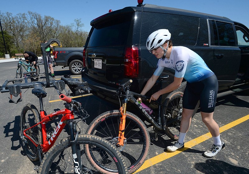 Cullen Darr, 14, of Jacksonville, Texas, prepares his mountain bike to ride at Centennial Park in Fayetteville in this April 8, 2021, file photo. Darr and his family were in town to ride in the inaugural OZ Trails U.S. Pro Cup, an Olympic mountain bike-qualifying event being sponsored by Experience Fayetteville. (NWA Democrat-Gazette/Andy Shupe)
