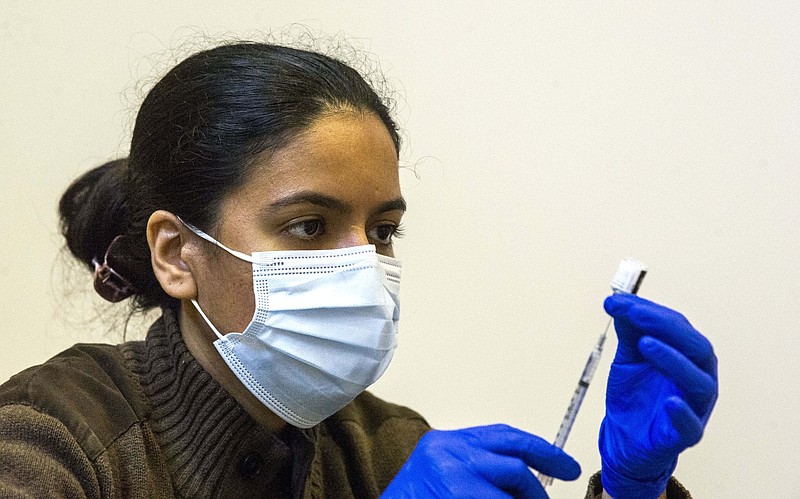 Neha Sharma, a pharmacist, draws a dose of the Moderna covid-19 vaccine at a UAMS vaccine clinic at University Park in Little Rock in this March 8, 2021, file photo. (Arkansas Democrat-Gazette/Stephen Swofford)