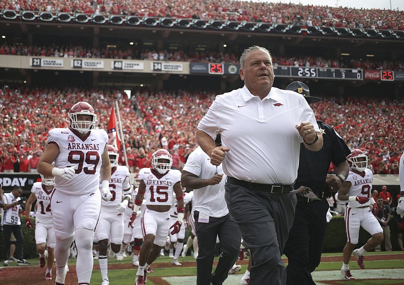 Arkansas head coach Sam Pittman runs out onto the field, Saturday, October 2, 2021 during a football game at Sanford Stadium in Athens, Ga. Check out nwaonline.com/211003Daily/ for today's photo gallery. .(NWA Democrat-Gazette/Charlie Kaijo)
