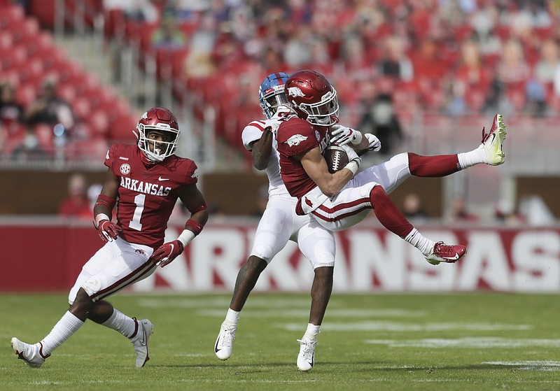 Arkansas defensive back Hudson Clark (17) intercepts a pass intended for Ole Miss wide receiver Elijah Moore (8), Saturday, October 17, 2020 during the third quarter of a football game at Donald W. Reynolds Razorback Stadium in Fayetteville. Check out nwaonline.com/201018Daily/ for today's photo gallery. .(NWA Democrat-Gazette/Charlie Kaijo)..