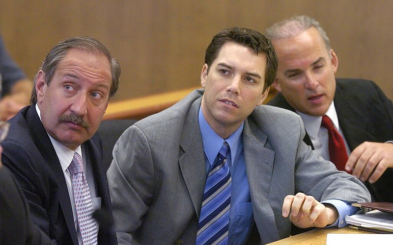 Scott Peterson (center), with defense attorneys Mark Geragos (left) and Pat Harris, listens to Judge Alfred A. Delucchi in a Redwood City, Calif., courtroom in this July 29, 2004, file photo. Peterson was convicted in the 2002 murders of his pregnant wife and unborn son. (Al Golub/The Modesto Bee via AP, Pool)