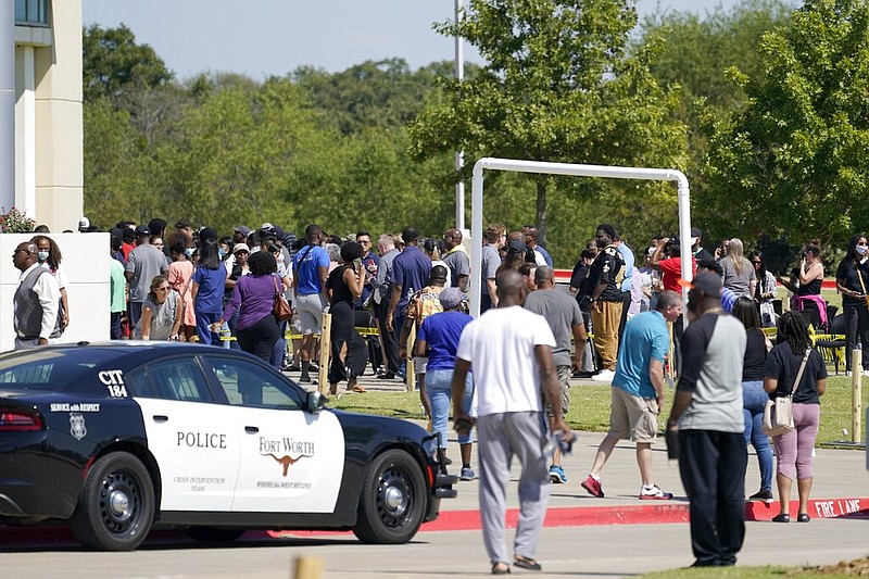 Families stand outside the Mansfield ISD Center for the Performing Arts waiting to be reunited with their children, Wednesday, Oct. 6, 2021 in Mansfield, Texas, following a shooting at the Timberview High School in Arlington. (AP/Tony Gutierrez)