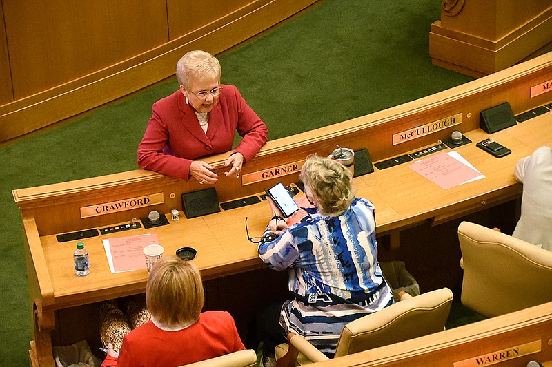 Rep. Nelda Speaks (top) talks with Rep. Cindy Crawford (left), R-Fort Smith, and Rep. Denise Garner, D-Fayetteville, during a recess Thursday. “I think this is a good map, I really do, and I think it’s a fair map,” Speaks said after the House approved her bill.
(Arkansas Democrat-Gazette/Staci Vandagriff)