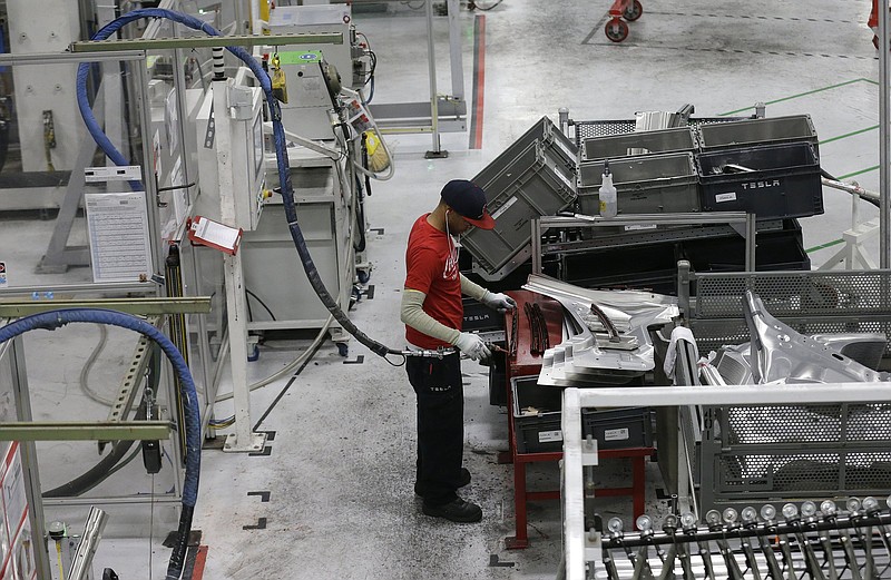 A Tesla employee works on metal parts in the Tesla factory in Fremont, Calif., in this file photo. Tesla CEO Elon Musk threatened in 2015 to pull the company’s factory and headquarters out of California. On Thursday, the company followed through, announcing plans to move its headquarters to Austin, Texas.
(AP)