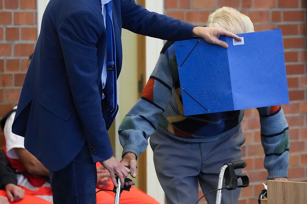 As they arrive at court in Brandenburg, Germany, on Thursday, an attorney covers the face of Josef S., 100, who’s on trial over his alleged role as a Nazi SS guard.
(AP/Markus Schreiber)