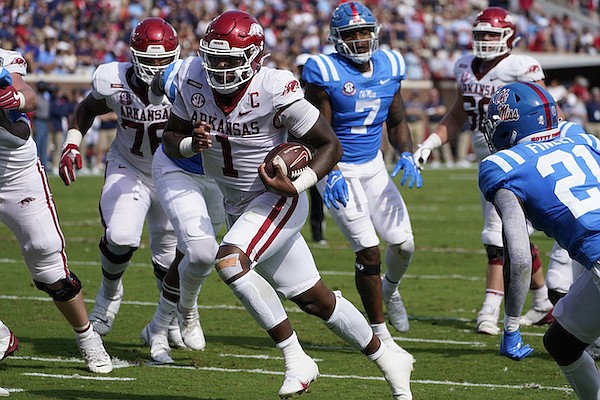 Arkansas quarterback KJ Jefferson (1) runs past Ole Miss defenders on his way to a five-yard touchdown run during the first half of an NCAA college football game, Saturday, Oct. 9, 2021, in Oxford, Miss. (AP Photo/Rogelio V. Solis)