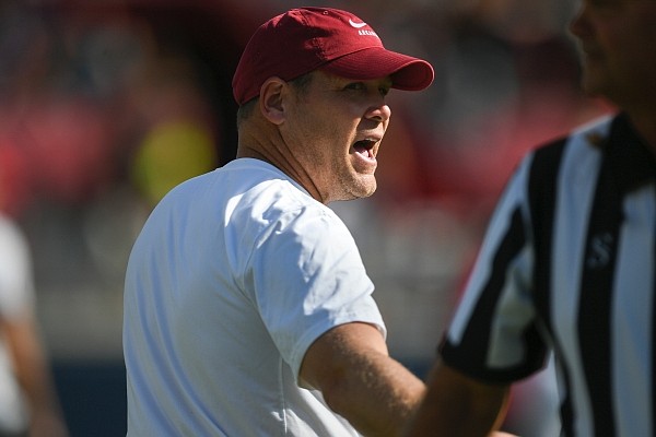 Arkansas defensive coordinator Barry Odom talks to an official on Saturday, Oct. 9, 2021 before a football game at Vaught Hemingway Stadium in Oxford, Miss.
