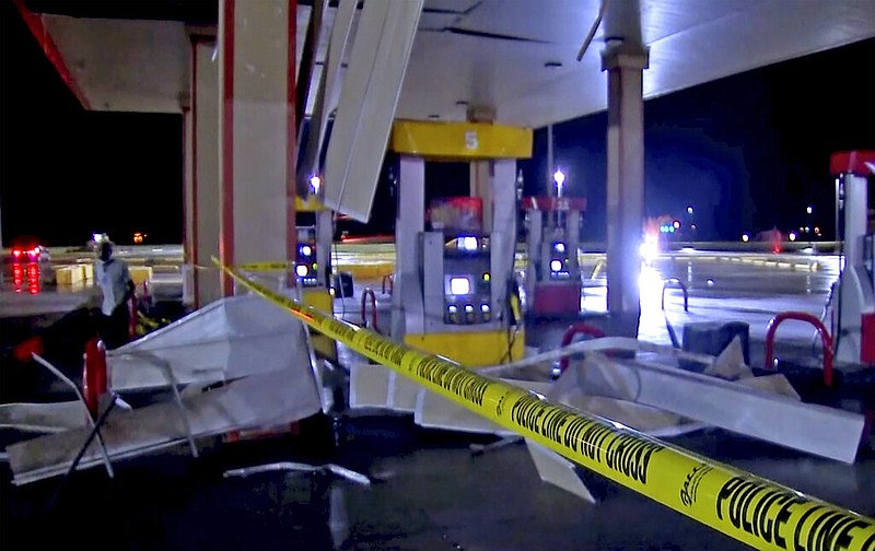 In this image made from video, debris from tornadoes pile around the pumps of a filling station late Sunday, Oct. 10, 2021, in Shawnee, Okla. (KWTV via AP)