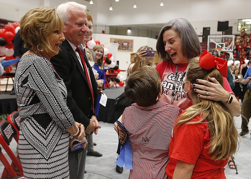 Jessica Saum gets a hug from her kids, Tucker, 9, and Maggie, 8, as parents Jeff and Linda Wheeler look on after Saum was named the 2022 Arkansas Teacher of the Year on Wednesday in Cabot. More photos at www.arkansasonline.com/1013saum/.
(Arkansas Democrat-Gazette/Thomas Metthe)