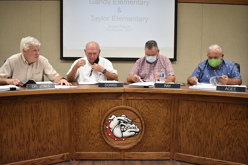 White Hall School Board President Raymond Jones (from left), district Superintendent Doug Dorris and board members Scott Ray and Roy Agee follow the agenda for a board meeting last month. 
(Pine Bluff Commercial/I.C. Murrell)