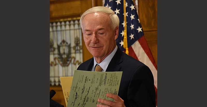 Gov. Asa Hutchinson, holding the redistricting bills Wednesday, said he was concerned about the impact of the new map on minority-group populations in the state but decided against a veto “out of deference to the legislative prerogative and the political process.”
(Arkansas Democrat-Gazette/Staci Vandagriff)