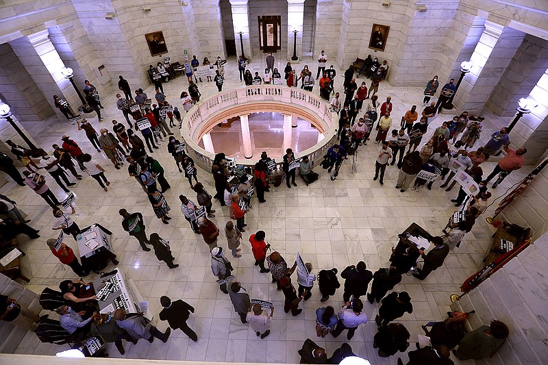 People gather Thursday in the rotunda of the state Capitol to rally against the state’s new congressional redistricting map that splits Pulaski County among three districts in what some speakers called blatant racial gerrymandering.
(Arkansas Democrat-Gazette/Thomas Metthe)