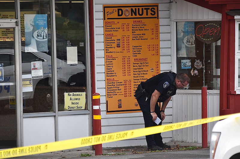 The North Little Rock Police Department investigates a shooting Thursday afternoon at Paul’s Donuts, next to North Little Rock High School. More photos at arkansasonline.com/1015nlrhs/.
(Arkansas Democrat-Gazette/Staci Vandagriff)