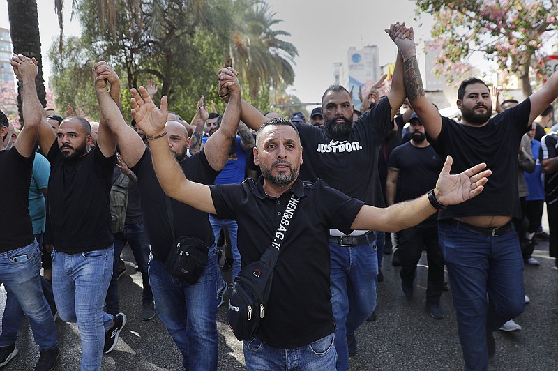 Supporters of the Hezbollah and Amal groups march Thursday outside the Justice Palace, in Beirut in protest against Judge Tarek Bitar, who Hezbollah and its allies accuse of singling out politicians for questioning, most of them allied with Hezbolla, in investigating last year’s deadly seaport blast.
(AP/Hussein Malla)