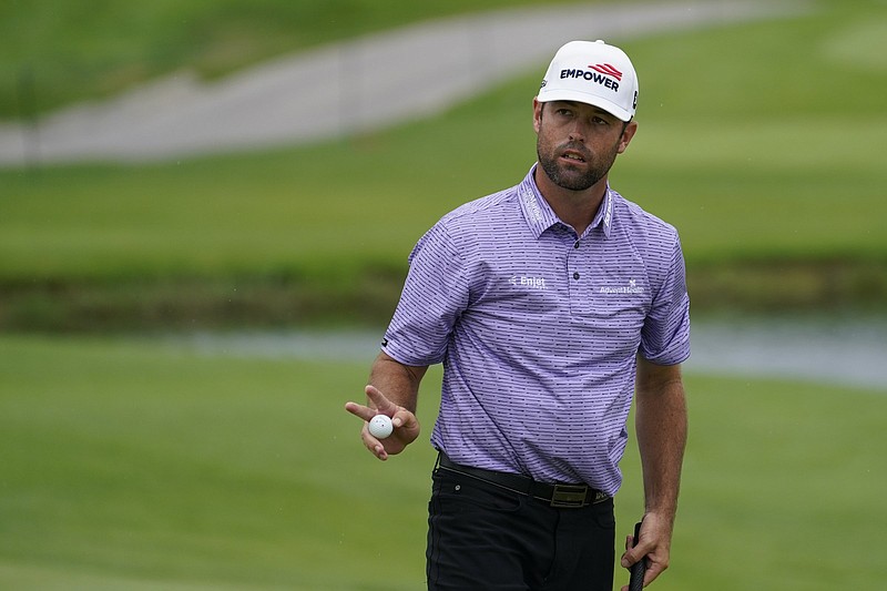 Robert Streb acknowledges spectators after sinking his put on the fourth green in the second round at the Northern Trust golf tournament, Friday, Aug. 20, 2021, at Liberty National Golf Course in Jersey City, N.J. (AP Photo/John Minchillo)
