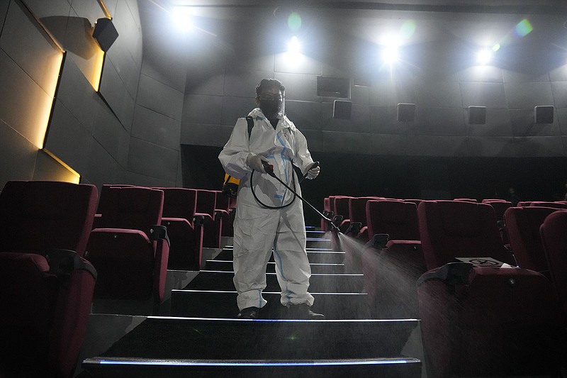 A worker sanitizes a movie house Thursday in Quezon City, Philippines, in preparation for reopening as government restrictions are being eased after a decline in covid-19 cases in that country.
(AP/Aaron Favila)