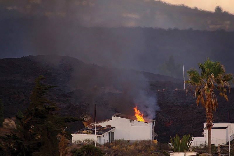 Lava from the Cumbre Vieja volcano ignites a house Wednesday on the Canary island of La Palma, Spain.
(AP/Daniel Roca)