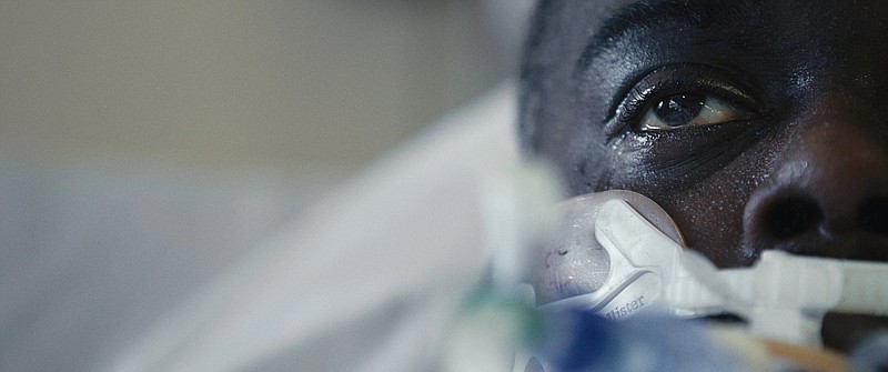 NYPD school safety officer Ahmed Ellis, a 35-year-old, first-generation American whose parents are from Guyana, lies in his hospital bed suffering from covid-19 in Matthew Heineman’s shattering documentary “The First Wave."