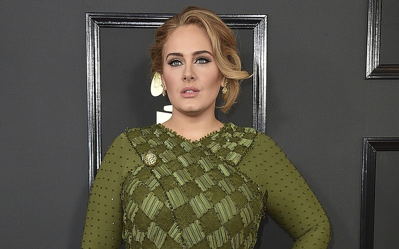 FILE - Adele arrives at the 59th annual Grammy Awards on Feb. 12, 2017, in Los Angeles. The singer will share custody of her 8-year-old son and won’t be paying child support to her now-ex-husband Simon Konecki. The couple separated in August of 2019, and Adele filed for divorce the following month. A Los Angeles judge finalized the divorce last week. (Photo by Jordan Strauss/Invision/AP, File)