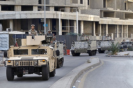 Lebanese soldiers patrol in armored vehicles Friday in Beirut at the site of Thursday’s clashes. Schools, banks and government offices across Lebanon shut down Friday following the violence.
(AP/Bilal Hussein)