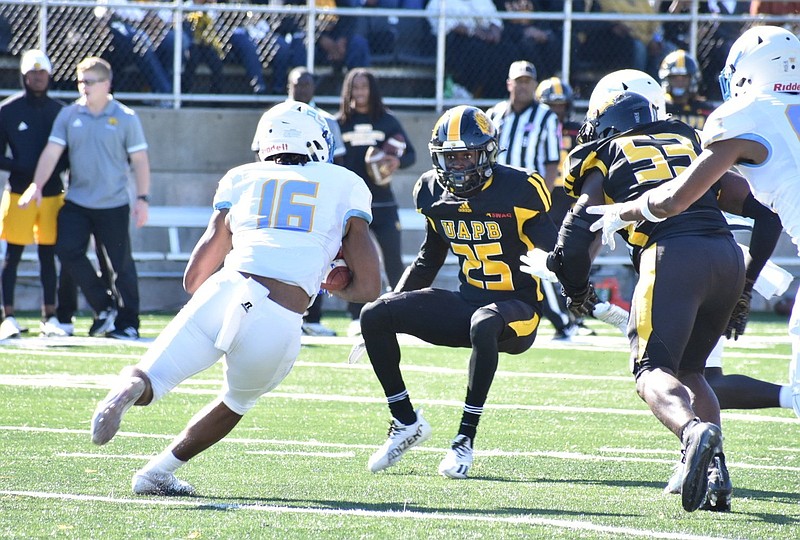 Southern running back Kobe Dillion runs into a double team of UAPB’s Stanleigh Bentley (25) and Isaac Peppers (53) in the second quarter of Saturday’s homecoming football game at Simmons Bank Field. 
(Pine Bluff Commercial/I.C. Murrell)