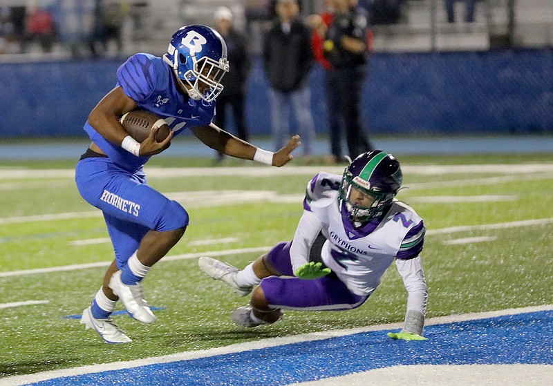 PHOTOS BY STEPHEN B. THORNTON .Bryant?s Chris Gannaway evades Little Rock Southwest's Julius Graves to score Bryant's 5th TD during the first half of their football game Friday Oct. 15, 2021 in Bryant. .More photos at arkansasonline.com/1016Bryant/..