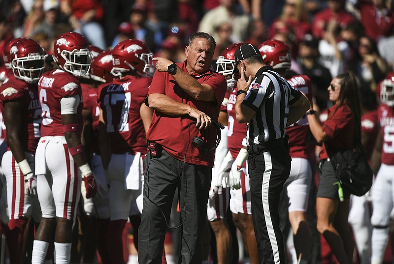 Arkansas head coach Sam Pittman speaks to an official, Saturday, Octobeer 16, 2021 during the first  quarter of a football game at Reynolds Razorback Stadium in Fayetteville. Check out nwaonline.com/211017Daily/ for today's photo gallery. .(NWA Democrat-Gazette/Charlie Kaijo)