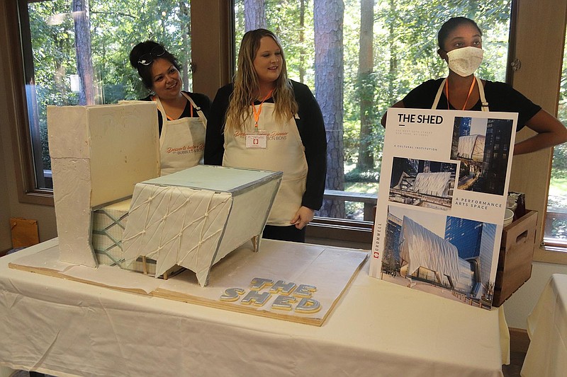 Jacinda Gregory, Emily Hill and Amber Banks of Cromwell Architects & Engineers with the firm's bakeoff-contest cake entry, a replica of The Shed in New York, at the second annual Dessert Before Dinner With Bubbles and Bon Bons .fundraiser for the Alex Foundation, October 3, 2021 at Garvan Woodland Gardens in Hot Springs..(Arkansas Democrat-Gazette/Helaine R. Williams)