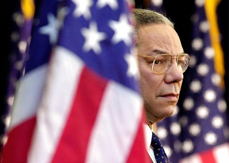 FILE - In this Feb. 15, 2001 file photo, Secretary of State Colin Powell looks on as President Bush addresses State Department employees at the State Department in Washington. (AP/Kenneth Lambert)