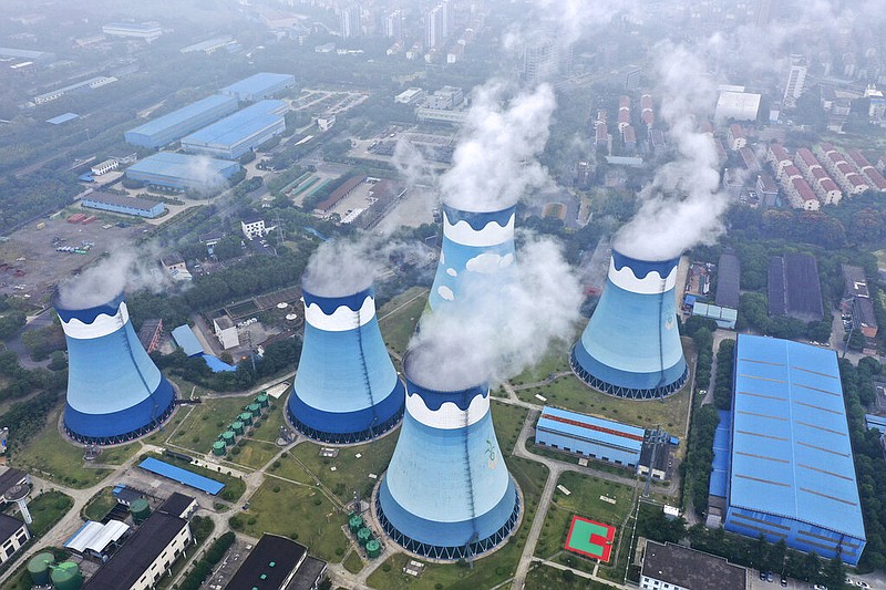 FILE - In this Sept. 27, 2021 file photo, steam billows out of the cooling towers at a coal-fired power station in Nanjing in east China's Jiangsu province. (Chinatopix via AP, file)