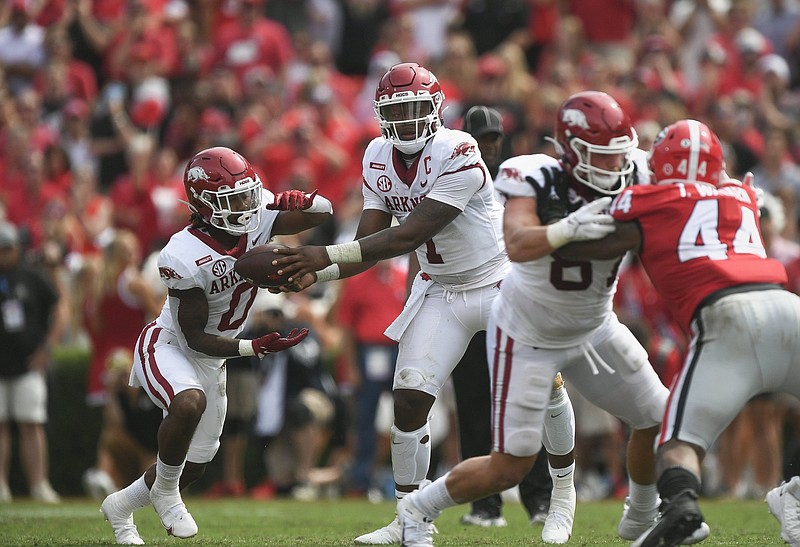 Arkansas quarterback KJ Jefferson and running back AJ Green (0) trigger the run-pass option earlier this season against Georgia. “Where is it? Did the quarterback keep it? Are we going to throw it or are we going to hand it off?” Razorbacks Coach Sam Pittman said when describing the RPO offensive philosophy.
(NWA Democrat-Gazette/Charlie Kaijo)