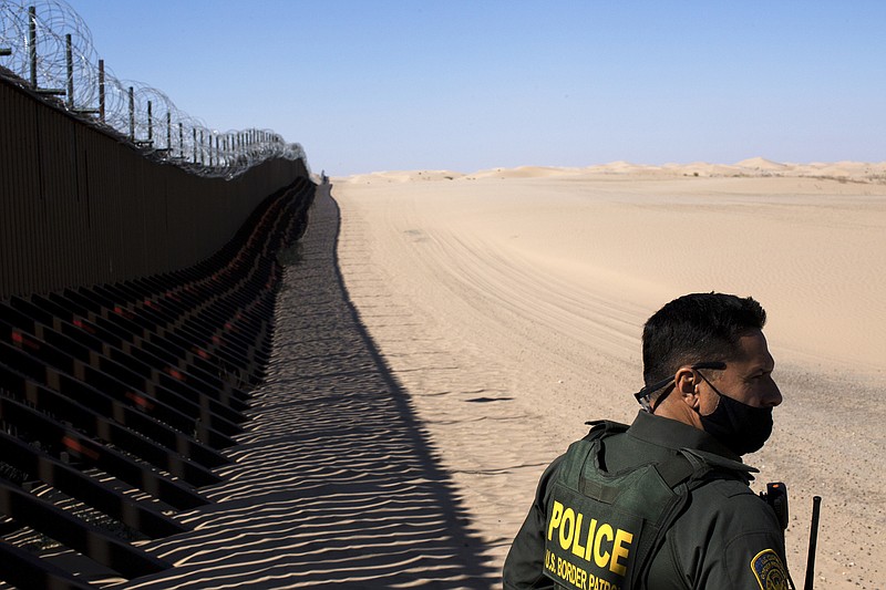 A U.S. Customs and Border Protection agent watches at the border wall in October 2020 at Imperial Sand Dunes Park in California. More than 1.3 million migrants have been taken into custody along the southern border in the nine months since President Joe Biden took office.
(The New York Times/Gabriella Angotti-Jones)