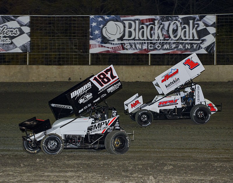 Benton’s Landon Crawley (187) races against his father, Tim Crawley, earlier this season at Riverside International Speedway in West Memphis. Landon, 13, will be competing this weekend in his first Short Track Nationals at I-30 Speedway in Little Rock.
(Special to the Democrat-Gazette/Jimmy Jones)