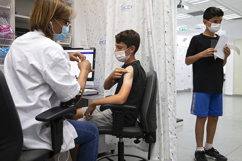 FILE - In this June 6, 2021 file photo, a youth receives a Pfizer-BioNTech COVID-19 vaccine in the central Israeli city of Rishon LeZion. (AP/Sebastian Scheiner)