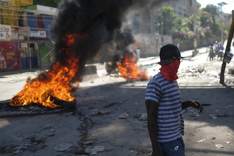 A man walks past as fires burn in the street in an anti-government protest Thursday in Port-au-Prince, Haiti.
(AP/Matias Delacroix)