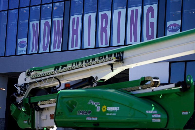 A hiring sign is displayed at a furniture store window on Friday, Sept. 17, 2021, in Downers Grove, Ill. (AP/Nam Y. Huh)