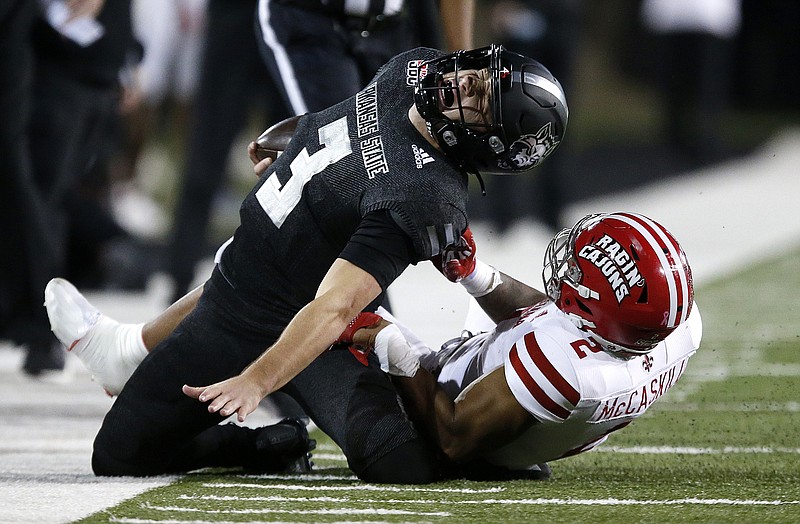 Arkansas State quarterback Layne Hatcher is brought down by Louisiana-Lafayette’s Lorenzo McCaskill on Thursday night in Jonesboro. McCaskill was penalized for a horse-collar tackle on the play. More photos available at arkansasonline.com/1022asu.
(Arkansas Democrat-Gazette/Thomas Metthe)